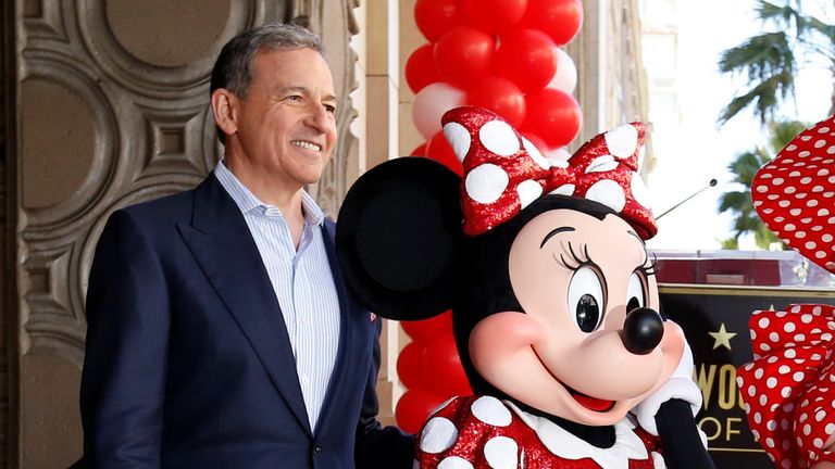 The character of Minnie Mouse poses on her star with singer Katy Perry and Chairman and CEO of The Walt Disney Company Bob Iger