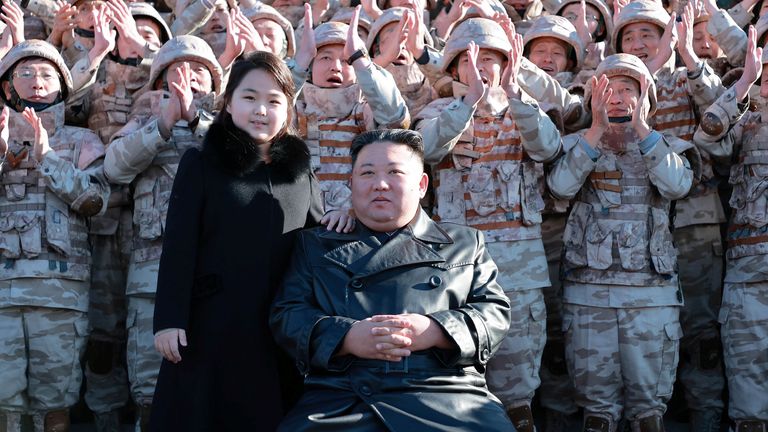 North Korean leader Kim Jong Un and his daughter attend a photo session with the scientists, engineers, military officials and others