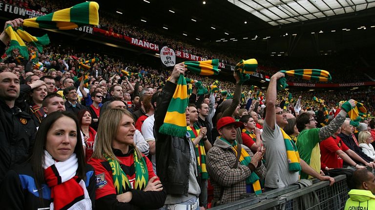 Man United fans wave green and gold scarves in protest at the Glazers in 2010