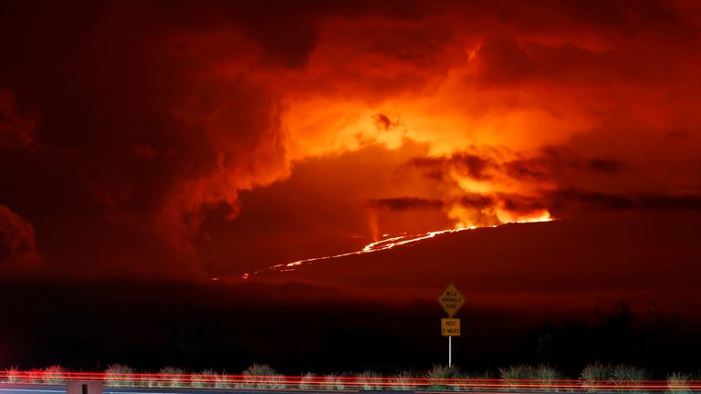 In this long camera exposure, cars drive down Saddle Road as Mauna Loa erupts in the distance
PIC:AP