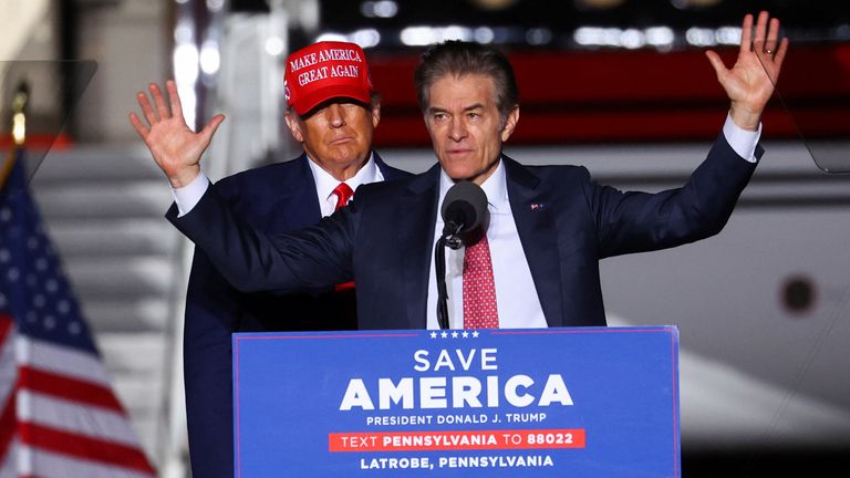 Former U.S. President Donald Trump looks on as Pennsylvania Republican U.S. Senate candidate Dr. Mehmet Oz speaks at a pre-election rally to support Republican candidates in Latrobe, Pennsylvania, U.S., November 5, 2022. REUTERS/Mike Segar