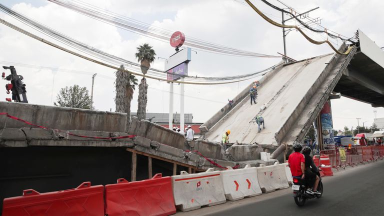 Employees work as part of the investigations at the site where an overpass for a metro partially collapsed with train cars on it, in Mexico City, Mexico May 19, 2021. REUTERS/ Henry Romero