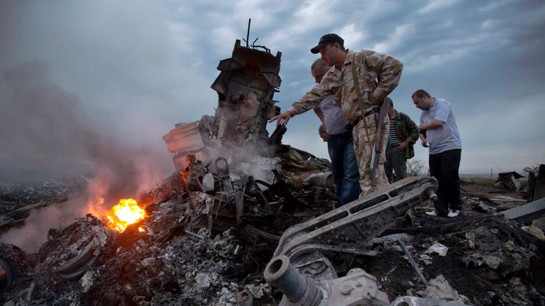 People inspect the crash site of a passenger plane near the village of Hrabove, Russian-controlled Donetsk region of Ukraine on Thursday, July 17, 2014