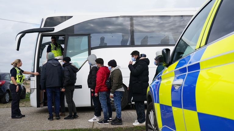 A group of people thought to be migrants board a bus in Dungeness following a small boat incident in the Channel. Picture date: Wednesday October 12, 2022.