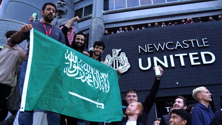 Newcastle United fans celebrate the Saudi-led takeover of the club