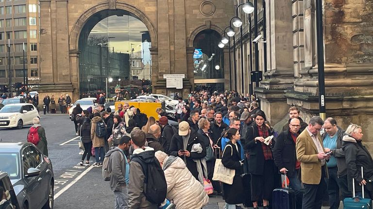 Centinaia di passeggeri del treno in coda fuori dalla stazione ferroviaria di Newcastle per gli autobus sostitutivi dopo che i treni per la Scozia sono stati cancellati a causa delle inondazioni. 