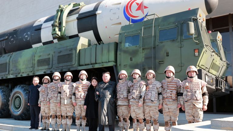 North Korean leader Kim Jong Un and his daughter attend a photo session with the scientists, engineers, military officials and others