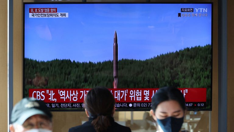 People watch a TV broadcasting a news report on North Korea firing a ballistic missile off its east coast, in Seoul, South Korea, November 2, 2022. REUTERS/Kim Hong-Ji
