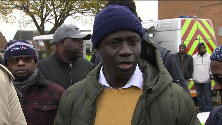 Fatoumatta Hydara&#39;s uncle Dawda Dibba attends a vigil in honour of the 28-year-old, who was killed following a house fire which also claimed the lives of her two children 