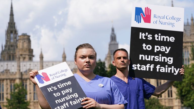 Nurses with banners outside the Royal College of Nursing in London