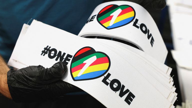 A worker carries One Love armbands, which are banned by FIFA at the World Cup Qatar 2022, in Utrecht, Netherlands November 23, 2022. REUTERS/Staff