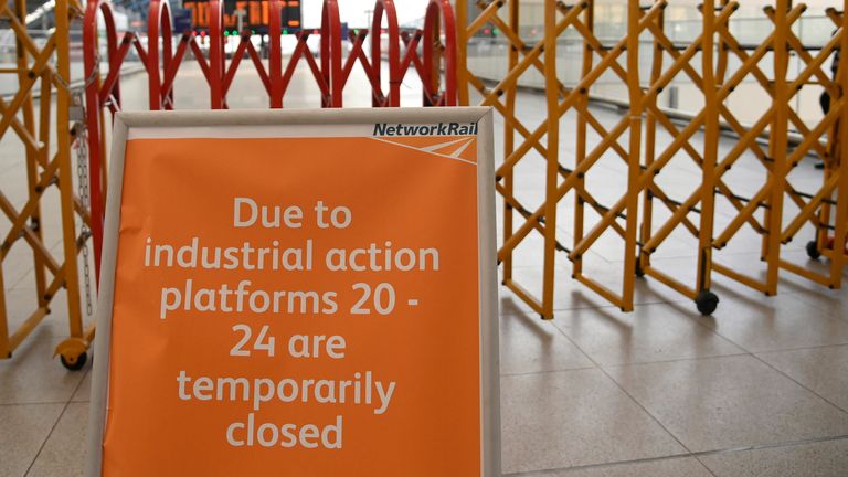 A passenger information message is displayed beside temporary closure barriers, as rail workers in Britain strike over pay and terms, at Waterloo Station in London, Britain, August 18, 2022. REUTERS/Toby Melville