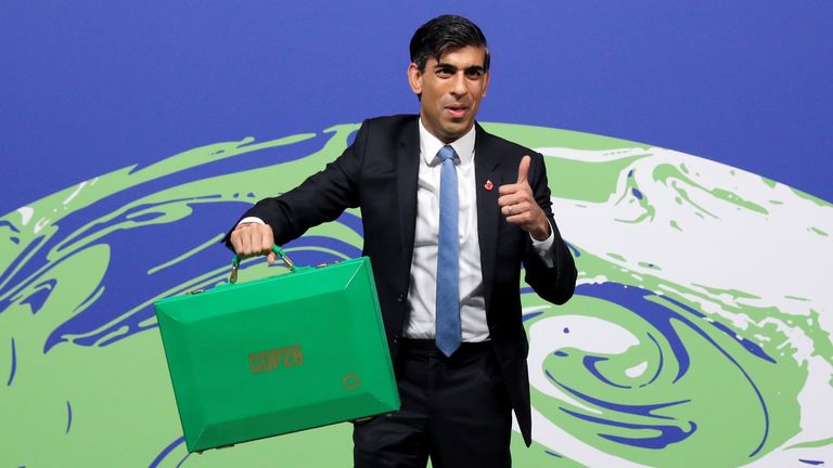 Britain&#39;s Chancellor of the Exchequer Rishi Sunak holds up a Green Box during the UN Climate Change Conference (COP26) in Glasgow, Scotland, Britain, November 3, 2021. Steve Reigate/Pool via REUTERS
