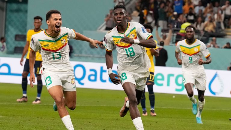 Senegal&#39;s Ismaila Sarr, right, celebrates with teammates after scoring a penalty, the opening goal of his team, during the World Cup group A soccer match between Ecuador and Senegal, at the Khalifa International Stadium in Doha, Qatar, Tuesday, Nov. 29, 2022. (AP Photo/Natacha Pisarenko)