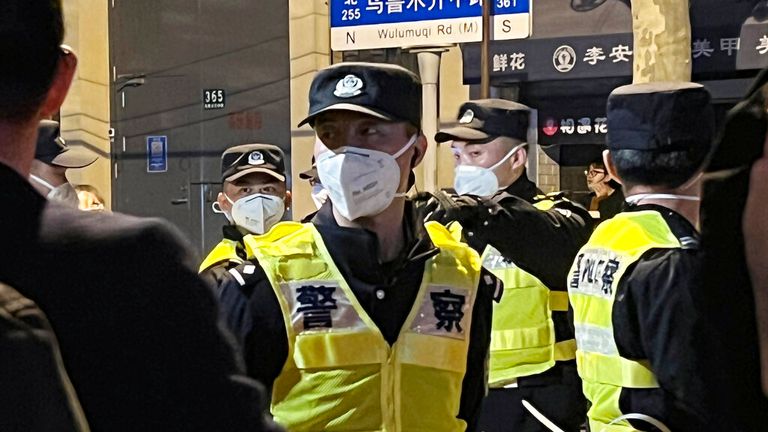 Masked police officers patrol protests in Shanghai