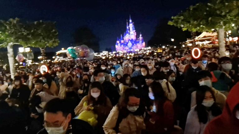 People make their way through the crowd gathered at Shanghai Disney Resort amidst the coronavirus disease (COVID-19) outbreak, in Shanghai, China October 31, 2022 in this screen grab from a video obtained by REUTERS.  THIS IMAGE HAS BEEN SUPPLIED BY A THIRD PARTY. NO RESALES. NO ARCHIVES.