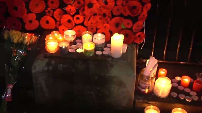 Remembrance poppies and candles at a vigil for Simon Lingard in his hometown
