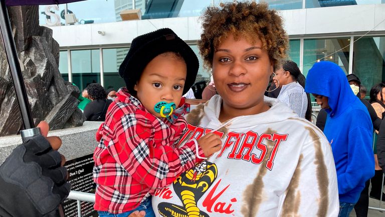 Jenifer Loving, 22, is standing in line with her son, Mateo, more than an hour before doors opened to fans for the memorial ceremony for slain rapper Takeoff, a member of the hip-hop trio Migos, in the state of Atlanta Farm Arena on Friday, November 11, 2022. He said the Migos ... the music represented the creativity and culture of the black community and he feared the group would be too saddened to make new music _ for a while.  ... It's ... just something you can play anywhere, and everybody will come out and dance, ... she said.  ... That's ... that's how it brings people together.  It's ... it's how the whole room fills with positivity ... (AP Photo / Sudhin Thanawala)