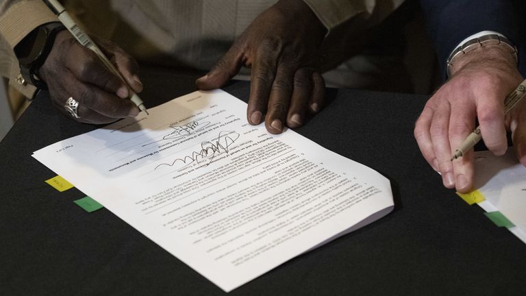 Professor Abba Tijani, General Director- General of NCMM signs documents at the Horniman Museum and Gardens in South London during a ceremony where the museum begun the official process of returning looted Benin bronzes to Nigeria