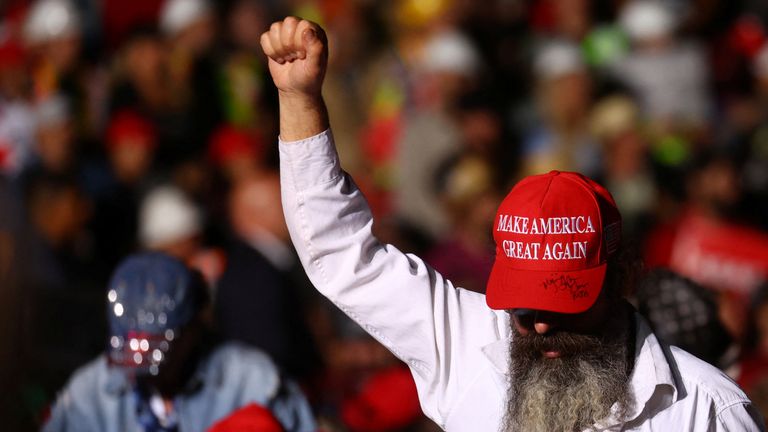 A man holds up his fist as he attends a pre-election rally by former U.S. President Donald Trump held in support of Republican candidates in Latrobe, Pennsylvania, U.S., November 5, 2022. REUTERS/Mike Segar