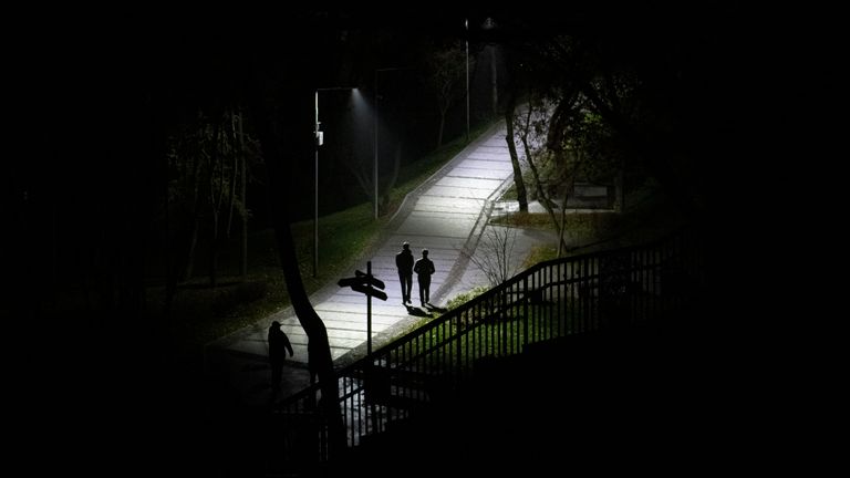 People walk in a park during a blackout in Kyiv, Ukraine. Pic AP