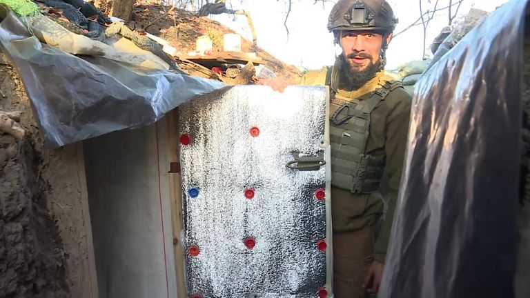 A shell-shocked Ukrainian soldier in a trench is getting taken