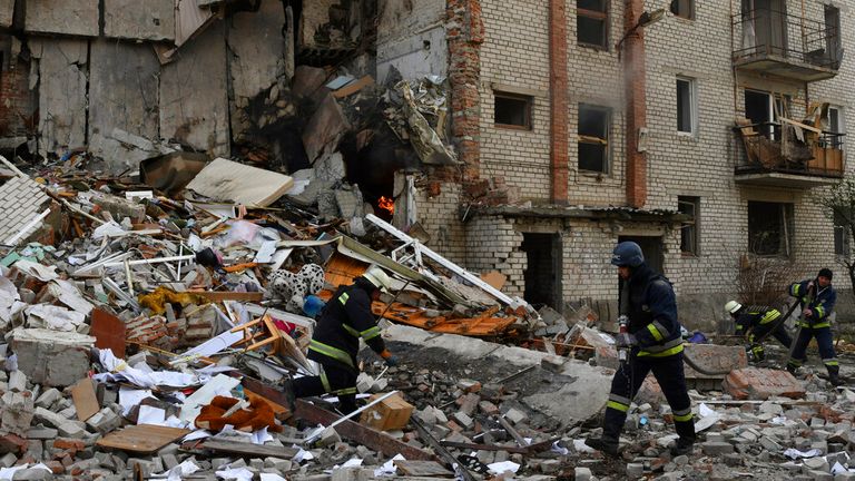 Firefighters work at the scene of a residential building damaged after Russian shelling in the liberated region of Lyman, Donetsk