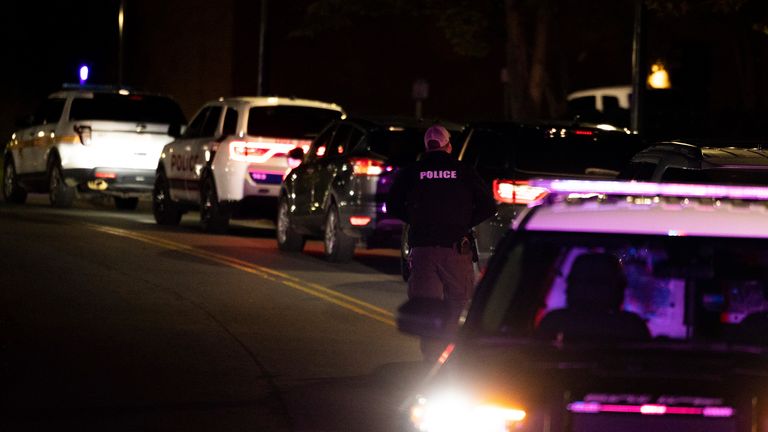 A police officer walks up Culbreath Road during an active shooter situation on the University of Virginia campus in Charlottesville, Va., on Monday, Nov. 14, 2022. A few people have been killed and a few others were wounded in a shooting late Sunday at the University of Virginia, according to the school...s president. Police are searching for a suspect, who remains at large. (Mike Kropf /The Daily Progress via AP)