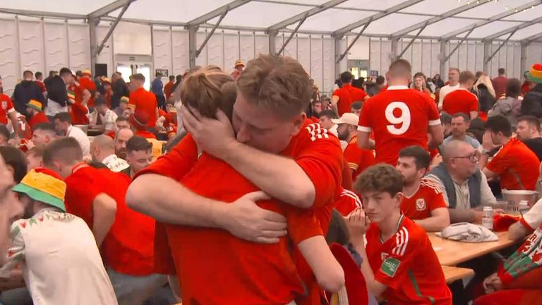 Wales fans hugging in Swansea after losing to Iran