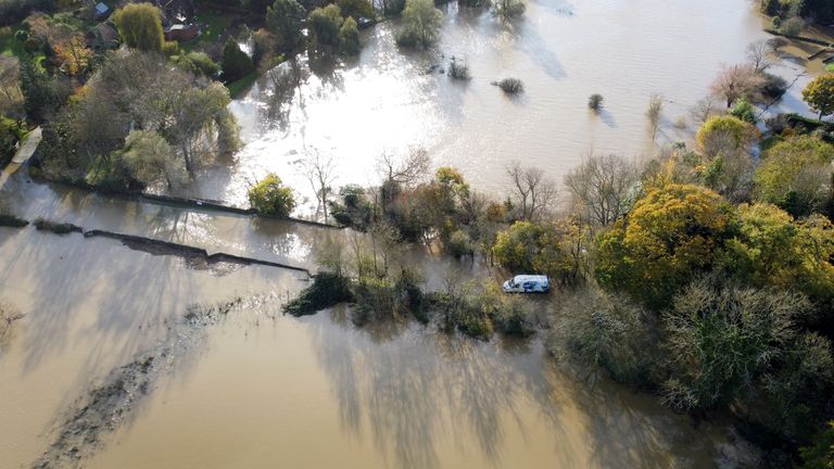 A van is left stranded in the floodwaters of the River Adur near Shermanbury in West Sussex