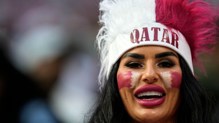 A female Qatar fan smiles to the camera prior he World Cup, group A soccer match between Qatar and Ecuador at the Al Bayt Stadium in Doha, Sunday, Nov. 20, 2022. (AP Photo/Natacha Pisarenko)