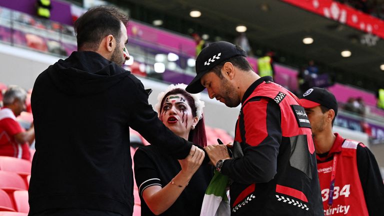 Police officers confiscate the fan&#39;s &#39;Women Life Freedom&#39; flag