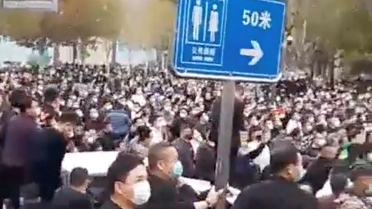 Residents gather in the street in Wuhan amid a coronavirus lockdown, as nationwide public anger mounts over the &#39;zero-COVID&#39; policy curbs