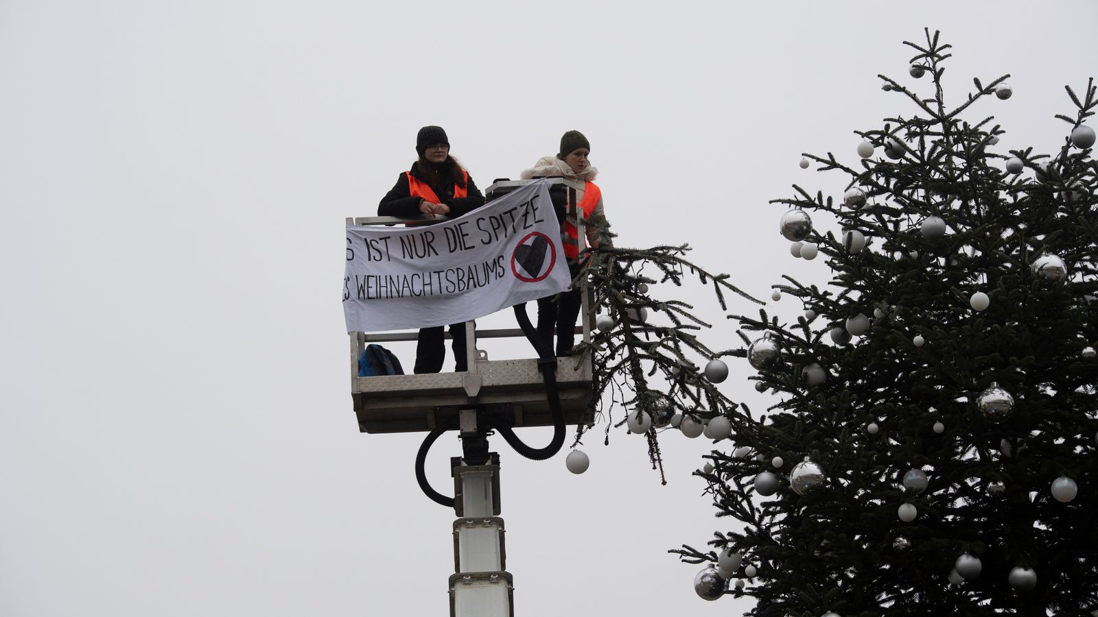 Activists cut off top of huge Christmas tree in climate protest in ...