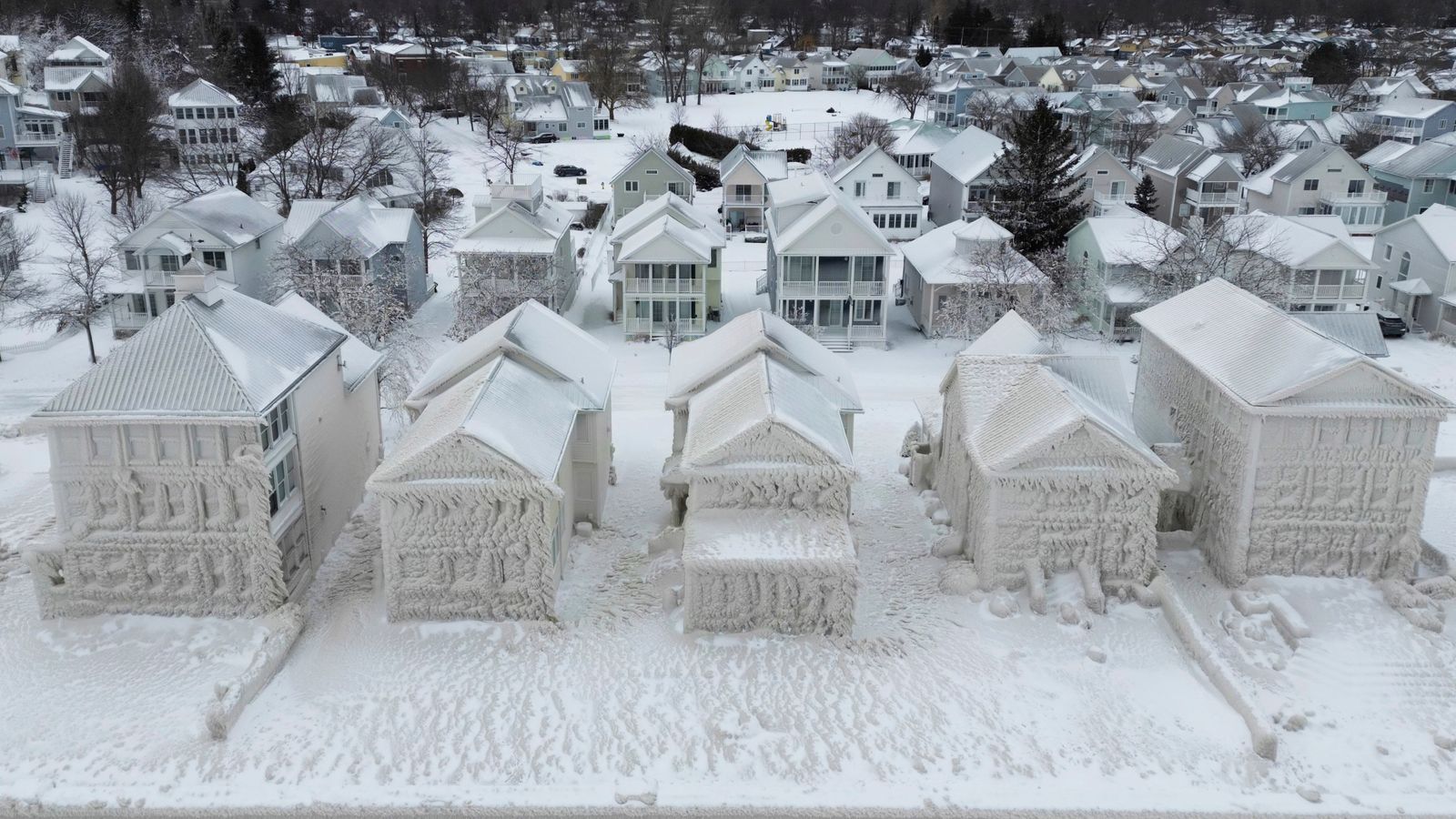 US snow storm covers houses in ice as people struggle to dig out after
