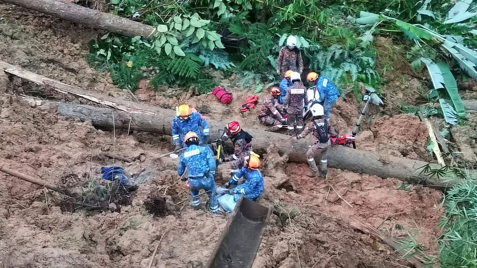 Three children among 18 killed in Malaysian landslide as rescuers dig for missing