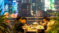 Citizens are enjoying hot pot in Hongyadong Scenic Area lights up at night in Chongqing, China, 8 December, 2022. (Imaginechina via AP Images)
