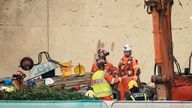 Emergency personnel at the scene of an explosion and fire at a block of flats in St Helier, Jersey. 