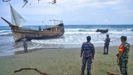 Indonesian military personnel inspect a wooden boat used to carry Rohingya refugees after it landed on Indra Patra beach in Ladong village, Aceh province, Indonesia, Sunday, Dec. 25, 2022. Dozens of hungry and weak Rohingya Muslims were found on a beach in Indonesia&#39;s northernmost province of Aceh on Sunday after weeks at sea, officials said. (AP Photo/Rahmat Mirza)