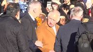 Screen grab taken from PA Video of close-protection officers ushering King Charles III away from the crowd as he was meeting members of the public during a visit to Luton