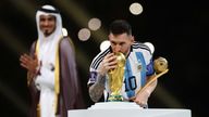 Argentina&#39;s Lionel Messi kisses the World Cup trophy after collecting the Golden Boot award
