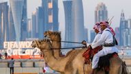 15 December 2022, Qatar, Doha: Mounted security forces ride their camels along the Corniche beach promenade. Pic: AP