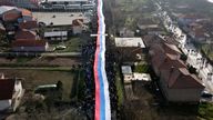Kosovo Serbs carry a giant Serbian flag during a protest near a barricade on the road near the village of Rudare, north of Serb-dominated part of ethnically divided town of Mitrovica, Kosovo, Thursday, Dec. 22, 2022. Pic: AP