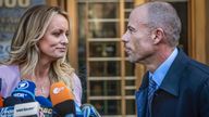FILE - Adult film actress Stormy Daniels, left, stands with her lawyer Michael Avenatti during a news conference outside federal court in New York, April 16, 2018. Avenatti was convicted by a jury on charges that he cheated porn actor Stormy Daniels out of nearly $300,000 she was supposed to get for writing a book about an alleged tryst with former president Donald Trump. (AP Photo/Mary Altaffer, File)                   
