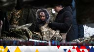 A woman and child shop for clothes, as Russia&#39;s attack on Ukraine continues, outside the Kyiv-Pasazhyrskyi railway station in Kyiv, Ukraine, December 3, 2022. REUTERS/Shannon Stapleton 