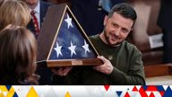 President Zelenskyy holds an American flag after it was gifted to him by House Speaker Nancy Pelosi
