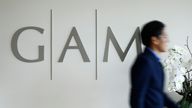 A man walks past the logo of GAM investment management company at its headquarters in Zurich, 