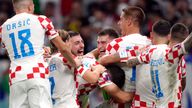 Croatia&#39;s goalkeeper Dominik Livakovic and team-mates celebrate after defeating Japan on penalties