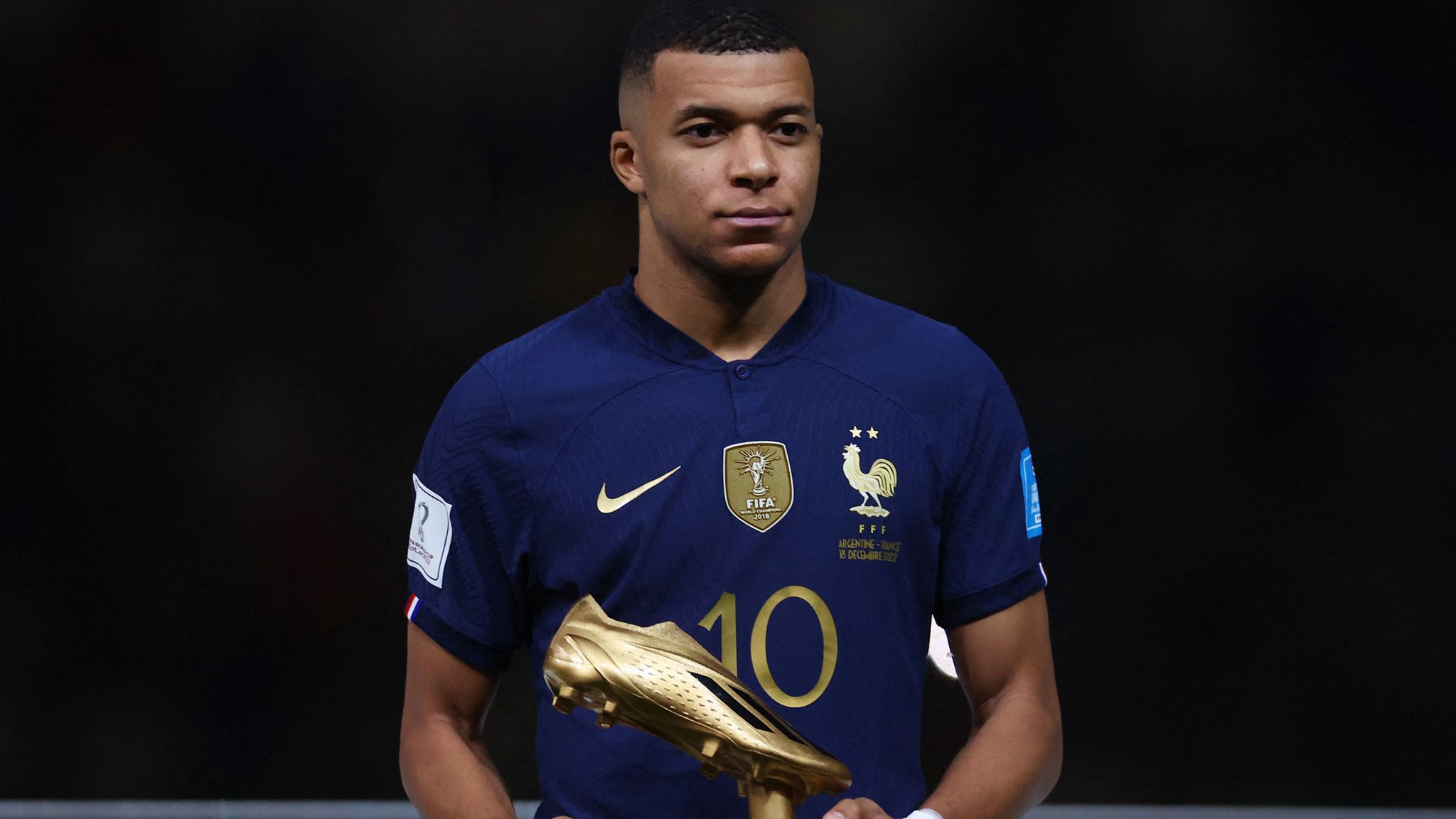 France's Kylian Mbappe poses with his Golden Boot award during the award ceremony after the match