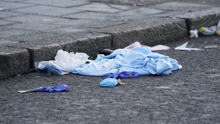Clothes and medical gloves lie on the floor outside Brixton O2 Academy